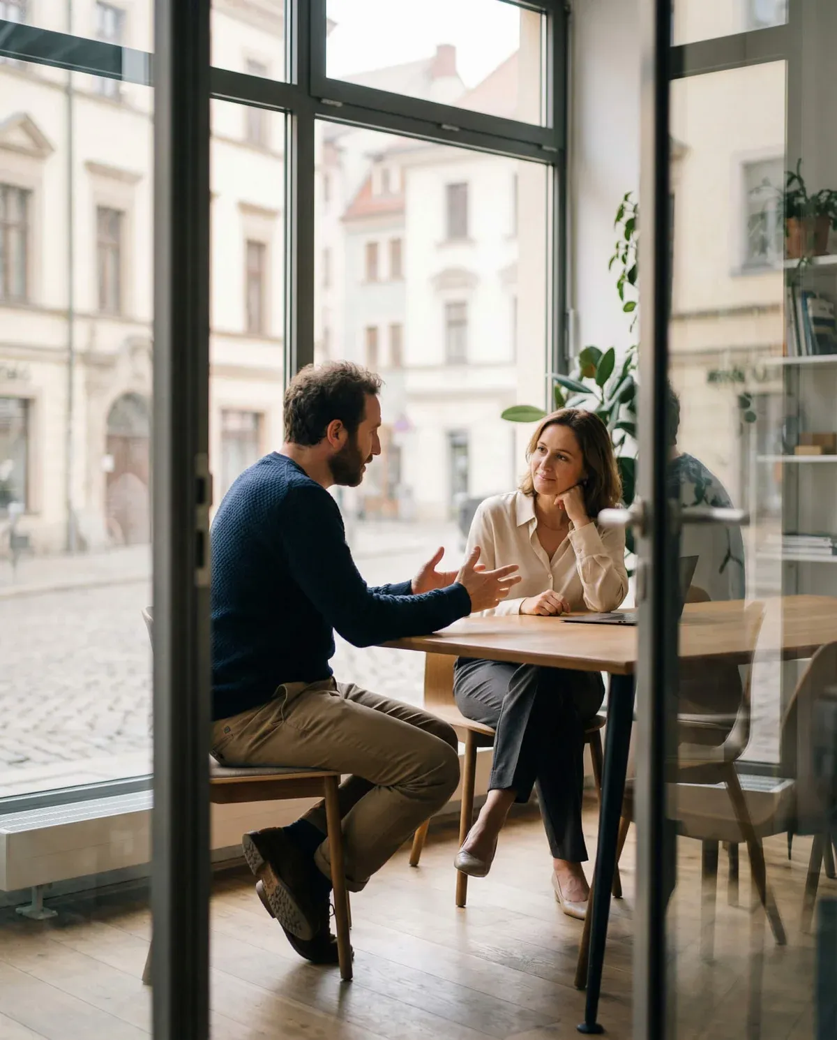 Recruiter and client in a focused conversation at a modern office